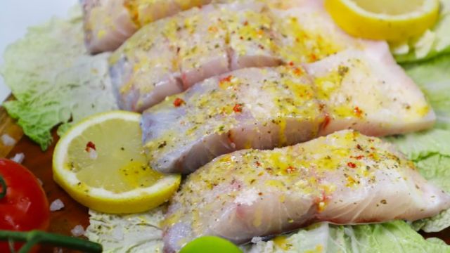 Seasoned fillets of barramundi ready for cooking