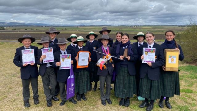 A group of students holding their award certificates.