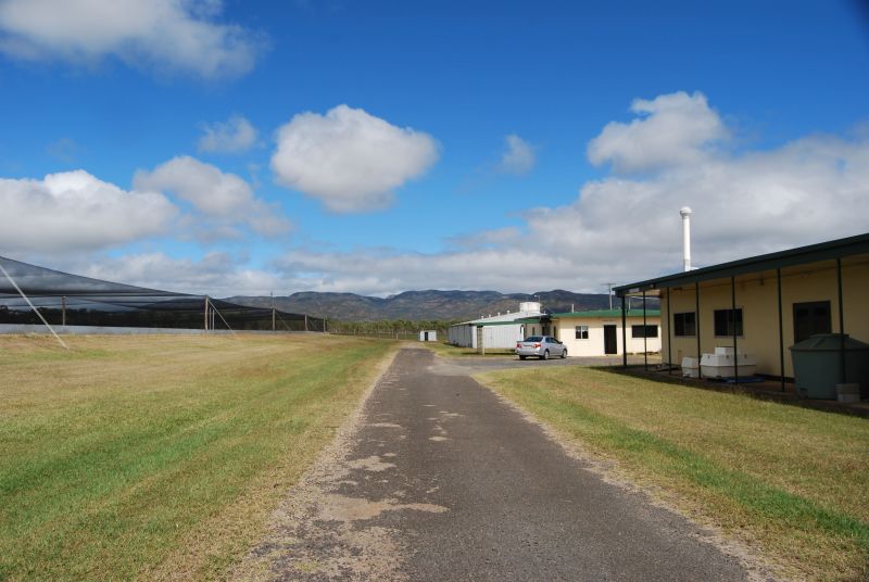 Walkamin Research Facility with buildings, access road and agricultural trial areas under a blue sky.
