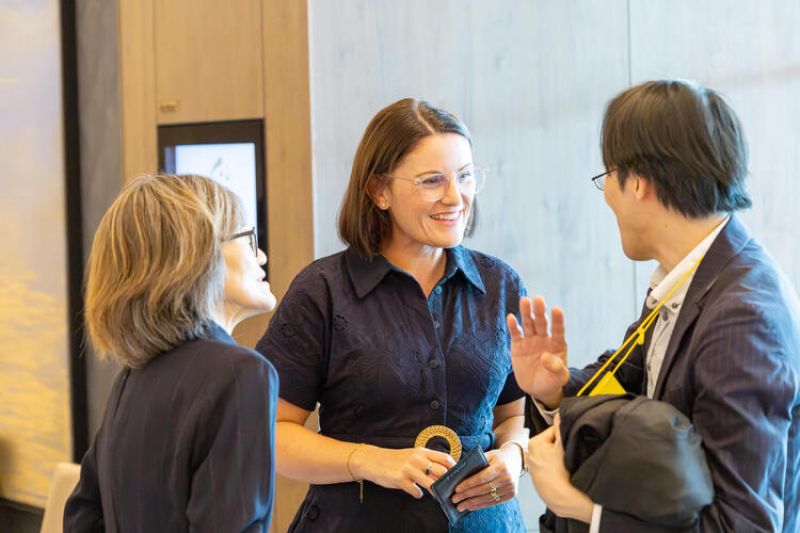 Two women talking to a man