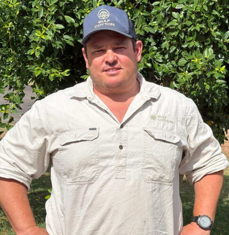A male standing with his hands on his hips looking at the camera