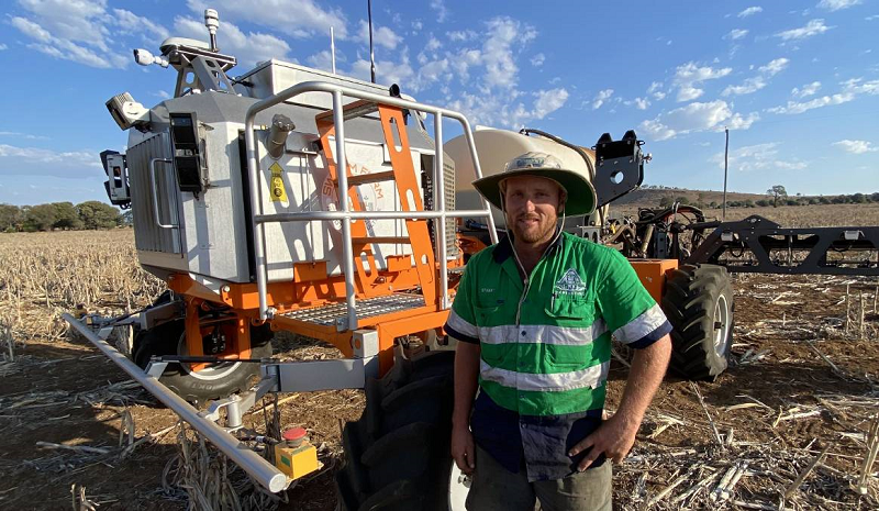 Stuart Johnstone standing in front of advanced field equipment used for precision farming