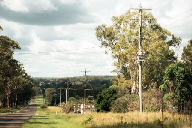 Power poles down the side of a country road.