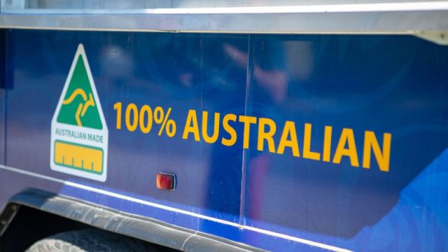 Australian-made logo on the side of a blue vehicle