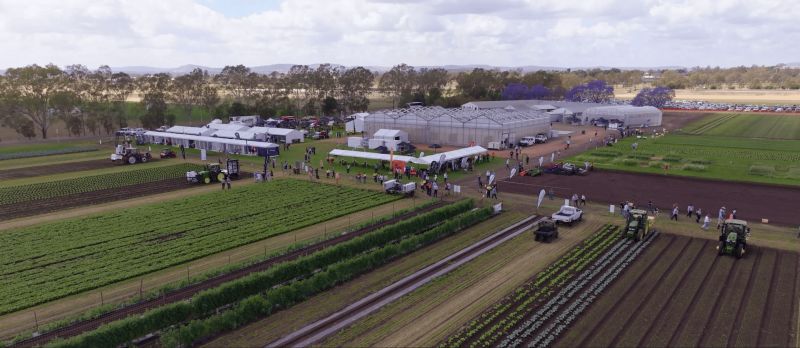 Aerial view of farm with buildings, people and machinery